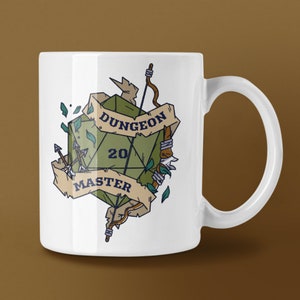 May include: White ceramic mug with a green twenty-sided die design and the words "DUNGEON MASTER" on a banner. The die displays the number 20. The design also includes arrows and leaves.