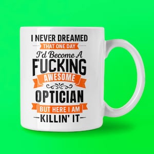 May include: A white ceramic mug with a black handle and the text "But First, Coffee" in a bold, black font. The mug is set against a blurred background, highlighting its clean design.