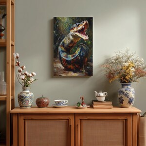 May include: A rectangular wall art print featuring a detailed oil painting of a coiled snake with its mouth open, displaying sharp teeth. The snake has iridescent scales in shades of blue, green, and orange, set against a dark, forest-like background.