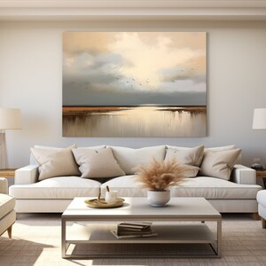 May include: A living room interior with a white sofa, two armchairs, a coffee table, and a large abstract painting of a seascape with birds flying over a body of water.