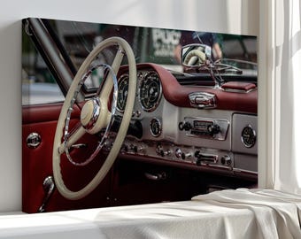 May include: A detailed shot of a vintage car's interior. The image shows a cream steering wheel, a red dashboard, and chrome details. The dashboard includes gauges and a radio. The car's interior is well-preserved and has a classic aesthetic.