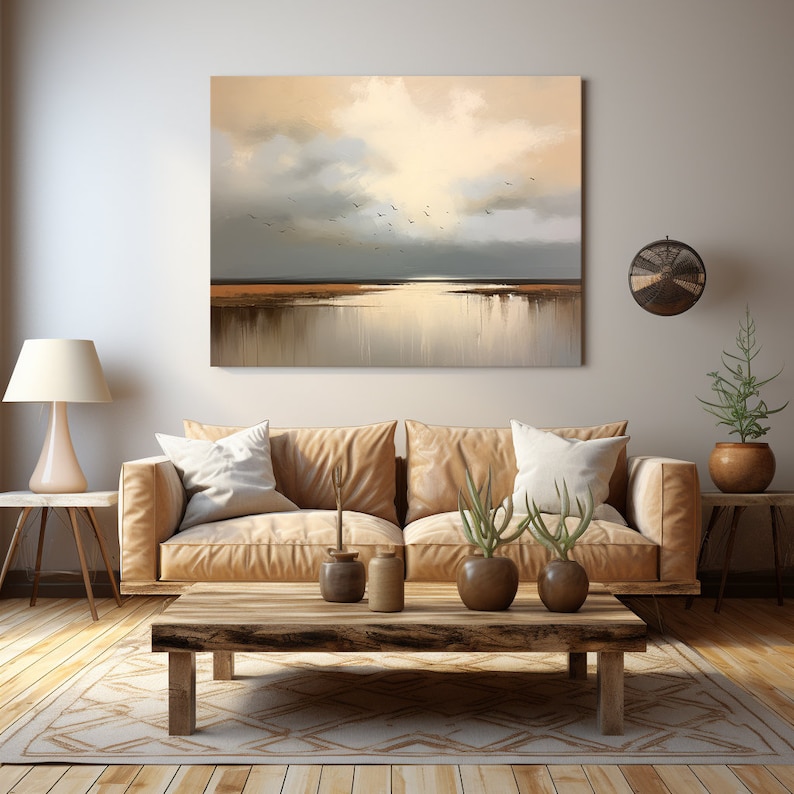 May include: A living room interior featuring a brown leather sofa, a wooden coffee table, and a painting depicting a seascape with birds flying over a body of water. The painting is hung on a light beige wall.