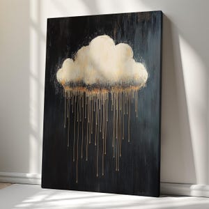 May include: Abstract canvas art depicting a cloud with gold dripping rain against a dark backdrop. The cloud is off-white with gold detailing, and the rain is gold. The artwork is propped against a white wall.