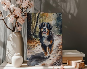 May include: Watercolor painting of a Bernese Mountain Dog running on a forest path. The dog has black, brown, and white fur. The artwork is displayed on a white surface with a vase of pink flowers.