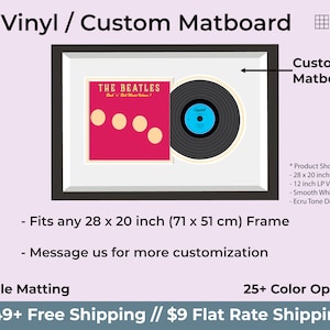 May include: A black rectangular frame containing a 12 inch LP vinyl record and a square album cover for The Beatles Rock 'n' Roll Music Volume 1. The display features a smooth white mat and an ecru tone double mat, fitting a 28 x 20 inch frame.