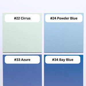 May include: A color palette display featuring five square swatches labeled with text. The top label reads #00 Cotton White. Below are four squares labeled #22 Cirrus in pale green, #24 Powder Blue in light blue, #33 Azure in medium blue, and #34 Bay Blue in dark blue.