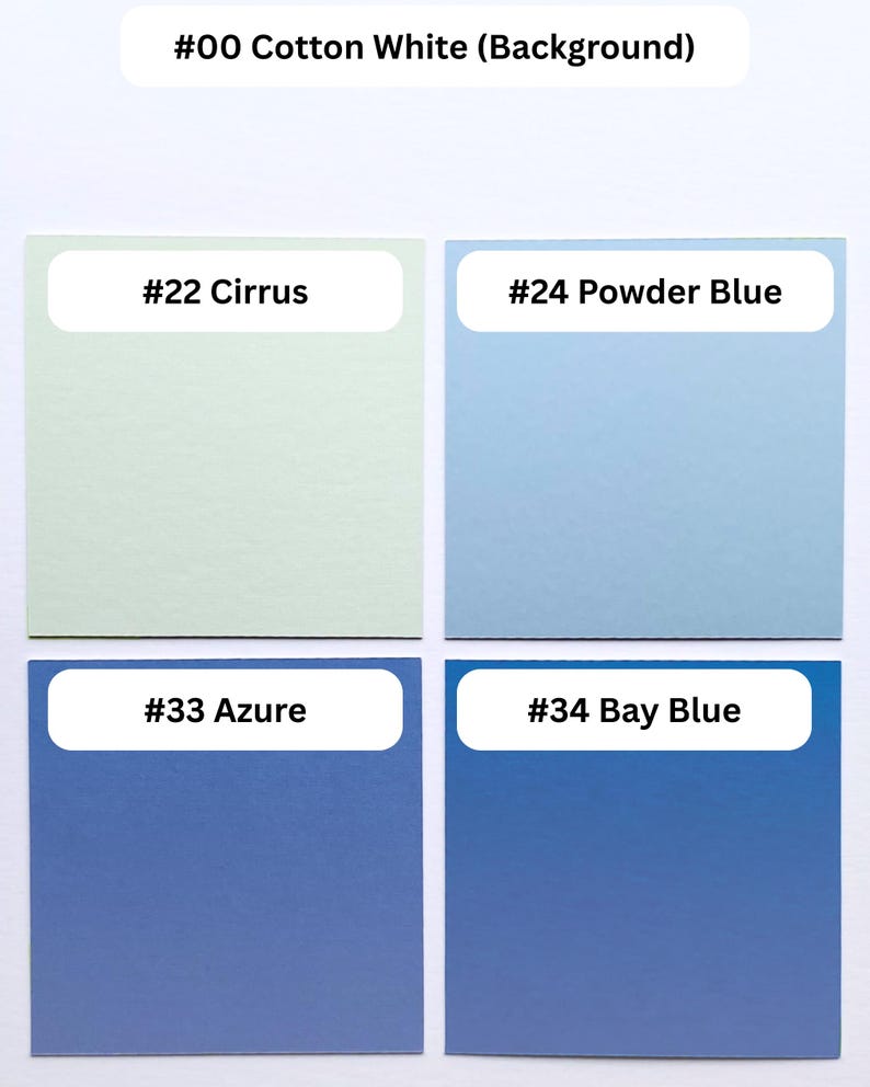 May include: A color palette display featuring five square swatches labeled with text. The top label reads #00 Cotton White. Below are four squares labeled #22 Cirrus in pale green, #24 Powder Blue in light blue, #33 Azure in medium blue, and #34 Bay Blue in dark blue.