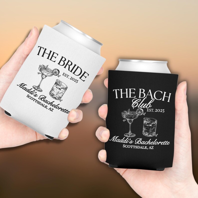 May include: Two black and white can coolers with a bachelorette party theme. One cooler says "The Bride" and the other says "The Bach Club". Both coolers have a cocktail glass and a margarita glass with a lime wedge. The text on both coolers says "Maddi's Bachelorette Scottsdale, AZ" and "EST. 2025".