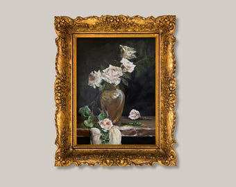 May include: An oil painting in a decorative gold frame depicting a still life of white roses in a brown vase. The flowers are arranged on a wooden surface against a dark background, with some petals and green leaves draped over the edge of the table.