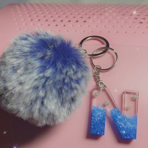 Resin N letter keychain with puff ball in blue