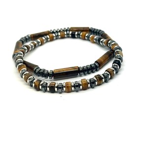 May include: A brown and silver beaded bracelet with tiger's eye and hematite beads.