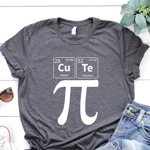 May include: A dark gray t-shirt with a white graphic of the mathematical symbol pi and the chemical symbols for copper and tellurium, which spell out "CuTe".