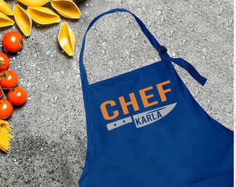 May include: Royal blue chef apron with a white knife graphic and the text "CHEF KARLA" in orange.