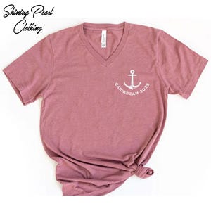 a pink shirt with a white anchor on it