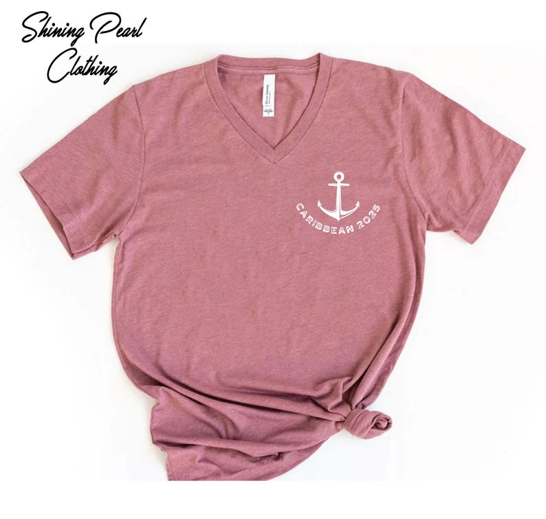 a pink shirt with a white anchor on it