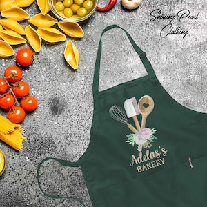 a green apron with the words adams's bakery on it