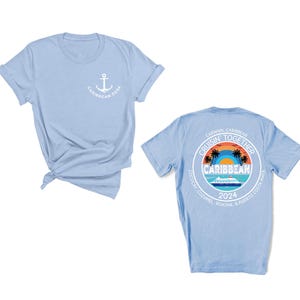 a blue shirt with a picture of a beach and an anchor on it