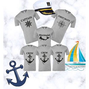 May include: A set of five grey t-shirts with nautical themed designs. The shirts feature a captain's hat, a compass, a mermaid, and an anchor. The shirts are perfect for a family vacation or a themed party.