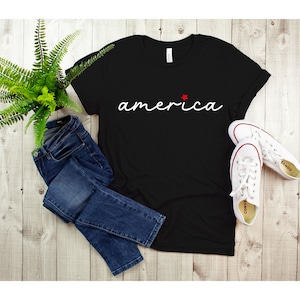 a black t - shirt with the word america on it