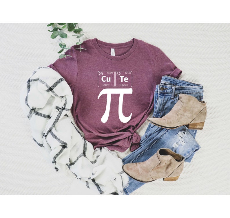 May include: A maroon t-shirt with a white graphic of the mathematical symbol pi and two periodic table elements: Cu (Copper) and Te (Tellurium).