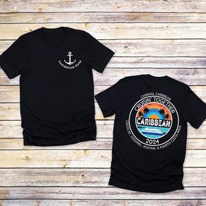 a couple of black shirts sitting on top of a wooden floor