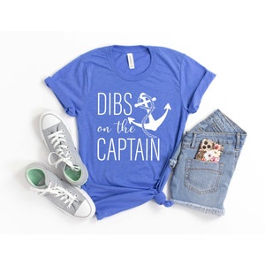 May include: A royal blue t-shirt with a white anchor and the text "DIBS on the CAPTAIN".