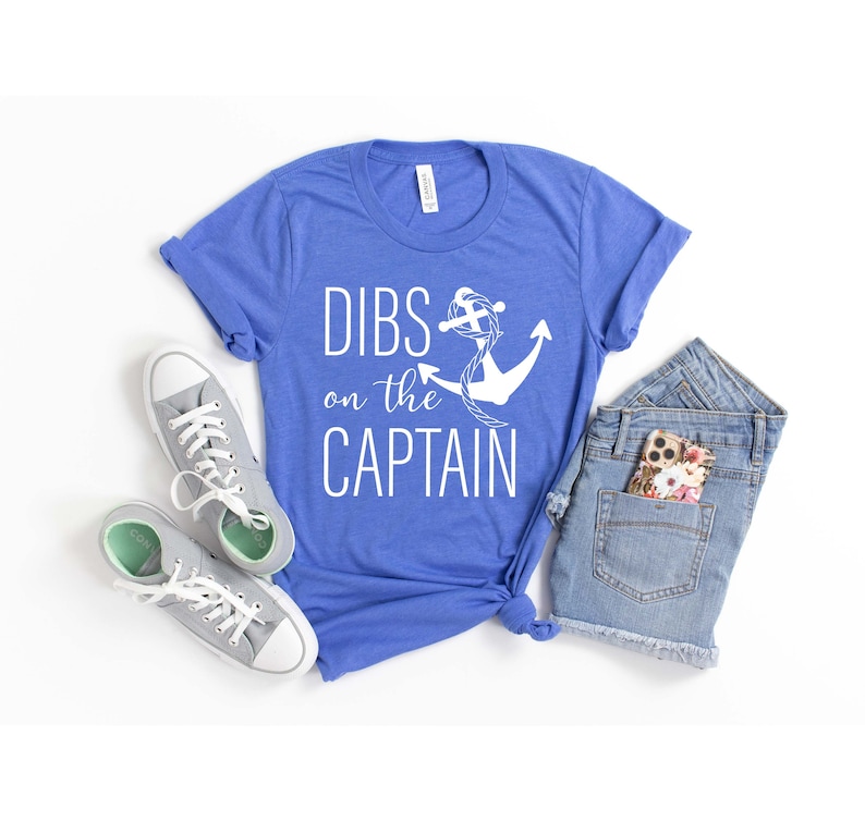 May include: A royal blue t-shirt with a white anchor and the text "DIBS on the CAPTAIN".