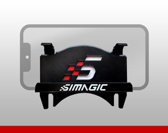 May include: A black plastic mounting bracket featuring the white text SIMAGIC and a stylized number 5 logo with a red and black checkered pattern. The bracket has two top clips and a horizontal ledge, designed to hold a smartphone device.