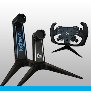 May include: Two black stands with blue and white accents, one featuring the word logitech and the other the G logo, alongside a black racing steering wheel controller with various buttons and a central G logo, all displayed against a plain background.