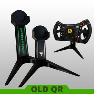 May include: Two black tripod stands for gaming equipment, one featuring green Thrustmaster branding and the other a white TM logo. A black Ferrari racing steering wheel with colorful buttons and a carbon fiber texture is mounted on a third matching stand.