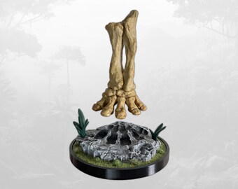May include: A beige, textured skeletal foot and lower leg bone structure hovering above a circular, gray, rocky base. The base features a central depression, small green plant accents, and a smooth black rim, creating a detailed display piece.