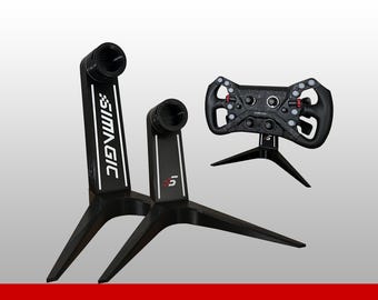 May include: Two black Simagic branded stands with tripod bases and a black racing steering wheel featuring multiple buttons, rotary dials, and red accents. The stands display the Simagic logo and the S5 model designation in white and red text.