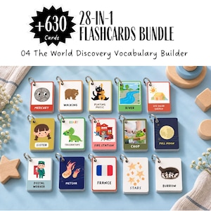 May include: A 28-in-1 flashcards bundle titled 04 The World Discovery Vocabulary Builder with +630 cards. The set includes rectangular cards on metal rings featuring illustrations and text for words like Mercury, Walking, Playing Music, River, Solar Energy, Sister, Triceratops, Fire Station, Chop, Full Moon, Postal Worker, Meteor, France, Stars, and Burrow.