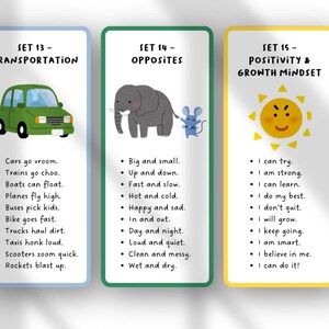 May include: Three educational flashcards with colorful borders. The first card features a green car and transportation-related phrases. The second card shows an elephant and mouse with opposite words. The third card has a smiling sun and positive affirmations.