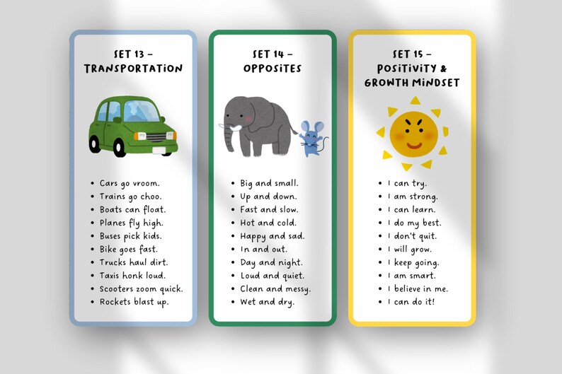 May include: Three educational flashcards with colorful borders. The first card features a green car and transportation-related phrases. The second card shows an elephant and mouse with opposite words. The third card has a smiling sun and positive affirmations.