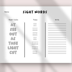 May include: A white worksheet with the title "SIGHT WORDS" in black text. The worksheet has sections for reading, tracing, and writing sight words. The sight words listed are "AT", "SEE", "OUT", "AS", "TAKE", "LIGHT", and "CUT".