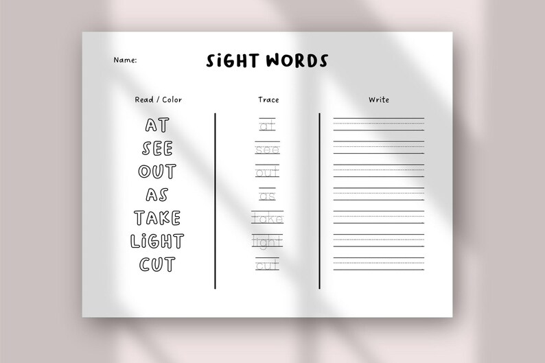 May include: A white worksheet with the title "SIGHT WORDS" in black text. The worksheet has sections for reading, tracing, and writing sight words. The sight words listed are "AT", "SEE", "OUT", "AS", "TAKE", "LIGHT", and "CUT".