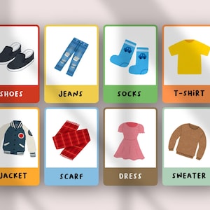 May include: A set of eight educational flashcards featuring illustrations of clothing items including black shoes, blue jeans, blue socks, a yellow t-shirt, a varsity jacket, a red plaid scarf, a pink dress, and a brown sweater with labels.
