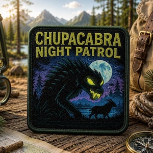 May include: A square embroidered patch with a dark green border featuring the text CHUPACABRA NIGHT PATROL in yellow. The graphic depicts a dark, spiky creature with glowing yellow eyes and teeth, a full moon, and a goat silhouette in a forest.