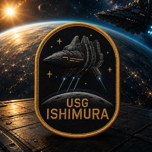 May include: An oval-shaped embroidered patch with a black background and a gold-colored border. The patch features a dark gray spaceship graphic, small gold stars, and the text USG ISHIMURA in gold lettering above a gray crescent moon shape.