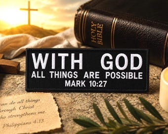May include: A black patch with white text that reads "WITH GOD ALL THINGS ARE POSSIBLE MARK 10:27". A wooden cross, a Bible, a lit candle, and a handwritten note with a Bible verse are also visible.