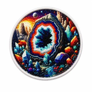 May include: Round embroidered patch featuring a colorful geode design. The geode has a blue and white center, surrounded by orange, red, and blue layers. The patch includes various colorful crystals and a starry sky background.