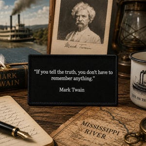May include: A rectangular black patch featuring the white text: "If you tell the truth, you don't have to remember anything." and "Mark Twain" centered below the quote. The patch has a stitched border and a matte finish, displaying clear, legible lettering.