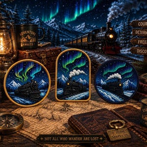May include: Three embroidered patches featuring a steam train traveling through a snowy mountain landscape under a vibrant green aurora borealis. The patches are circular and arched, displayed on a map with a compass, lantern, and metal tag.