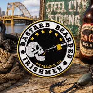 May include: A circular embroidered patch featuring a white skull drinking from a bottle on a black background. The border is white with yellow trim, displaying the text BASTARD BEARDED IRISHMEN and PITTSBURG, PA, along with five yellow stars.