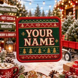 May include: A square embroidered patch featuring a dark green center with the text YOUR NAME in cream letters. The design includes red and green borders with gold-colored Christmas tree and snowflake patterns in a knit-style motif.