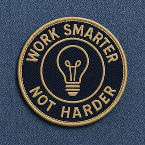 May include: Embroidered patch with the text "WORK SMARTER NOT HARDER" in gold thread. A gold outline surrounds the navy blue patch, which features a lightbulb graphic in the center.