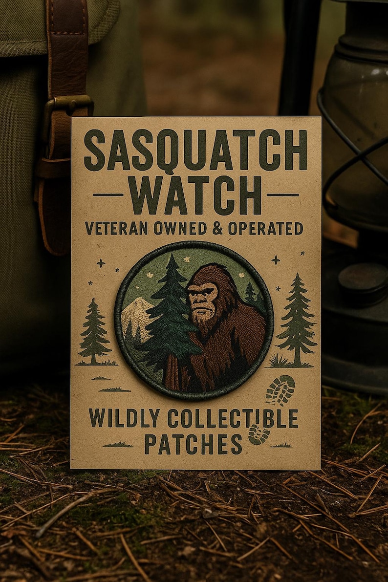 May include: A rectangular patch with the text "SASQUATCH WATCH" and "WILDLY COLLECTIBLE PATCHES". The patch features a circular design with a brown Bigfoot illustration, trees, and a mountain scene. The patch is on a brown background.