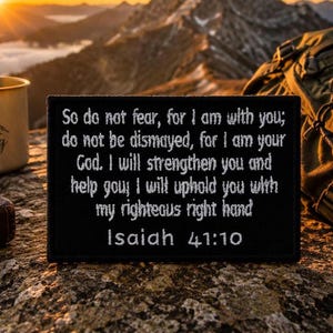 May include: A rectangular black patch featuring white embroidered text that reads: So do not fear, for I am with you; do not be dismayed, for I am your God. I will strengthen you and help you; I will uphold you with my righteous right hand Isaiah 41:10.
