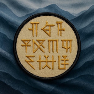 May include: A circular patch with gold-colored, stylized characters on a tan background, framed by a black border. The patch is set against a blue, textured backdrop, creating a contrast between the warm tones of the patch and the cool tones of the background.